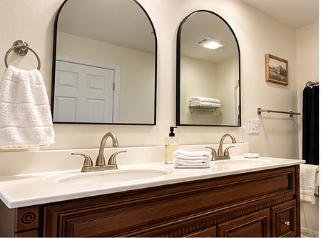 Bathroom double vanity with arched mirrors