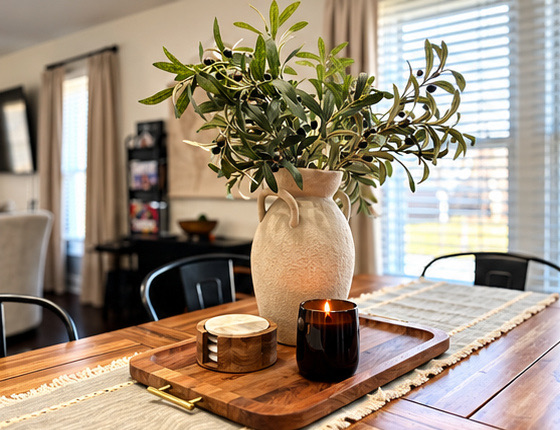 Farmhouse dining table set with greenery and candles