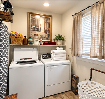 Laundry room with washer, dryer and fresh towels
